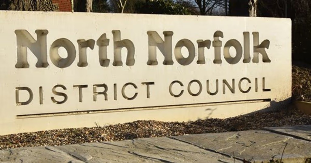 North Norfolk District Council name board with coat of arms and website address north-norfolk.gov.uk