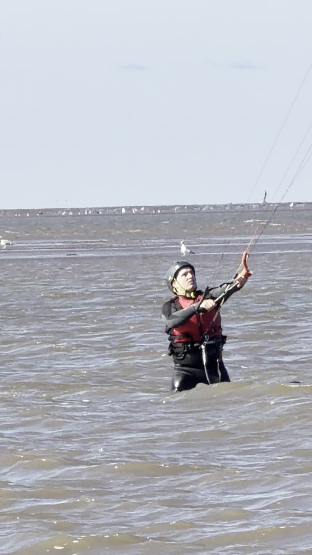 Nigel on kite bar waist deep The Wash yellow hat red jacket beginner session Hunstanton North Norfolk UK
